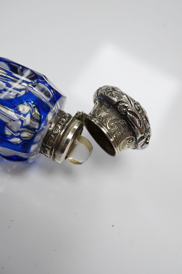 A 19th century silver topped blue overlay glass scent bottle, 11cm long. Condition - fine chips to base